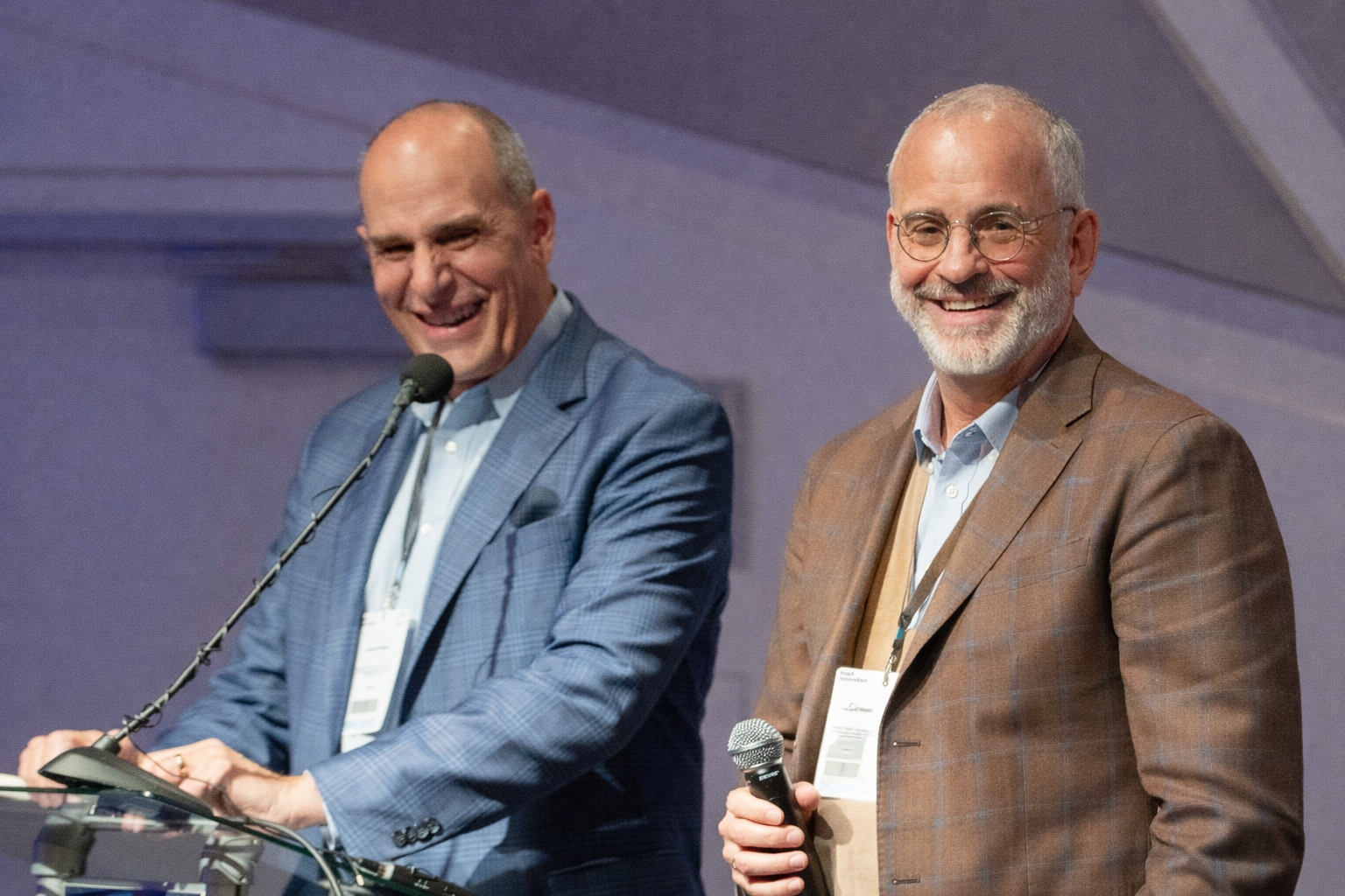 Founding partners at a speaking event